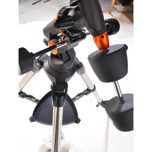 558 - A Celestron AstroMaster 130 telescope on tripod stand together with accessories & motors. Box not in... 