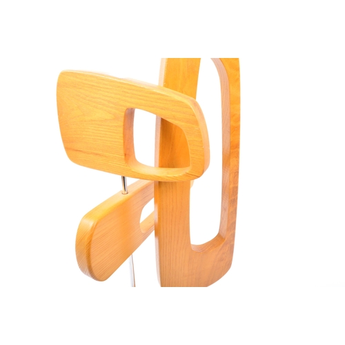 567 - A contemporary wooden abstract table top sculpture. The sculpture being made of three pierced concep... 