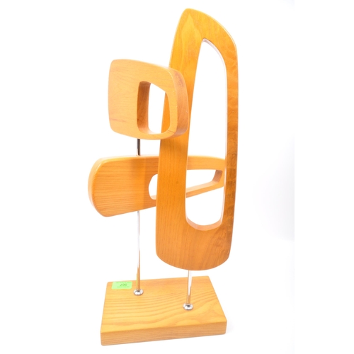 567 - A contemporary wooden abstract table top sculpture. The sculpture being made of three pierced concep... 
