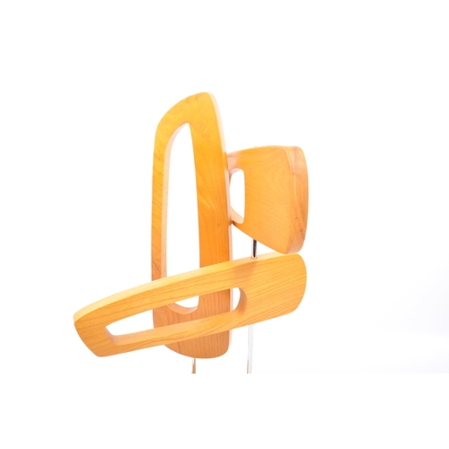 567 - A contemporary wooden abstract table top sculpture. The sculpture being made of three pierced concep... 