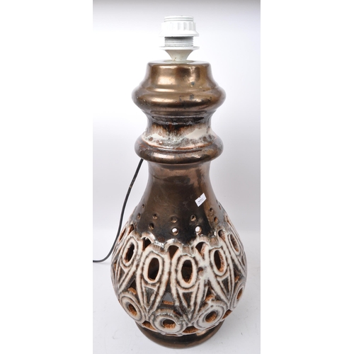 568 - A pair of 20th Century West German style pottery table lamp bases. Having a tiered top into a taperi... 