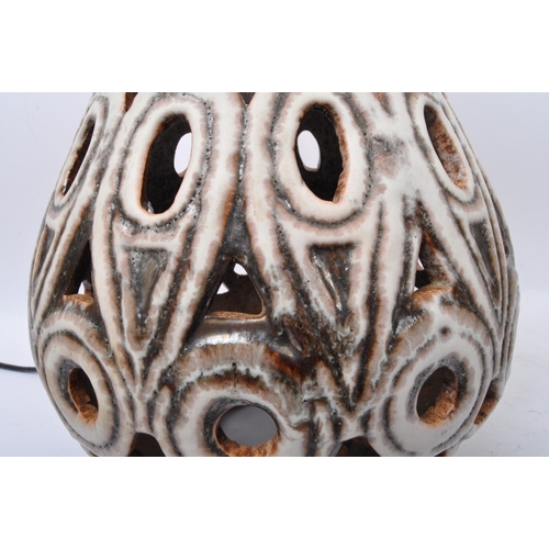 568 - A pair of 20th Century West German style pottery table lamp bases. Having a tiered top into a taperi... 