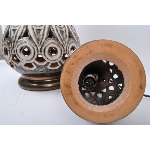 568 - A pair of 20th Century West German style pottery table lamp bases. Having a tiered top into a taperi... 