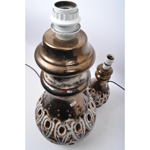 568 - A pair of 20th Century West German style pottery table lamp bases. Having a tiered top into a taperi... 