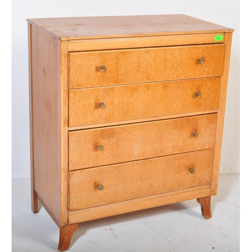572 - A retro vintage Lebus furniture oak chest of drawers. The bank of four straight drawers having turne... 