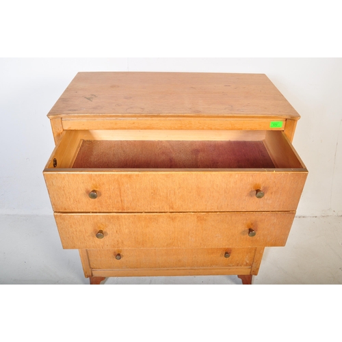 572 - A retro vintage Lebus furniture oak chest of drawers. The bank of four straight drawers having turne... 