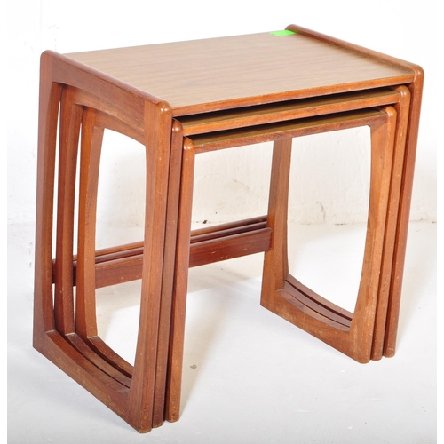 573 - A vintage retro mid 20th century circa. 1960's nest of tables having teak wood supports resembling G... 