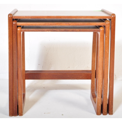 573 - A vintage retro mid 20th century circa. 1960's nest of tables having teak wood supports resembling G... 