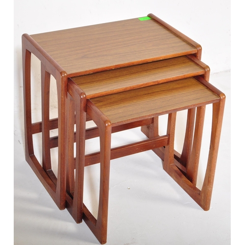 573 - A vintage retro mid 20th century circa. 1960's nest of tables having teak wood supports resembling G... 