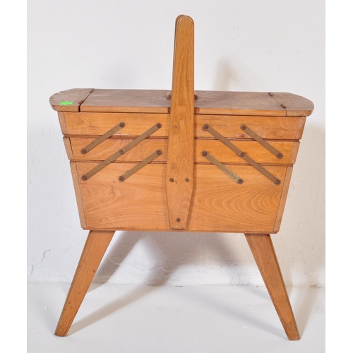 574 - A vintage retro mid 20th century circa. 1960's teak wood metamorphic sewing box having bar handle wi... 