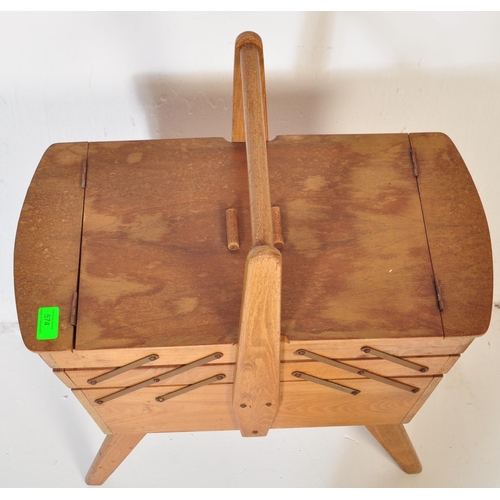 574 - A vintage retro mid 20th century circa. 1960's teak wood metamorphic sewing box having bar handle wi... 