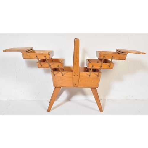 574 - A vintage retro mid 20th century circa. 1960's teak wood metamorphic sewing box having bar handle wi... 