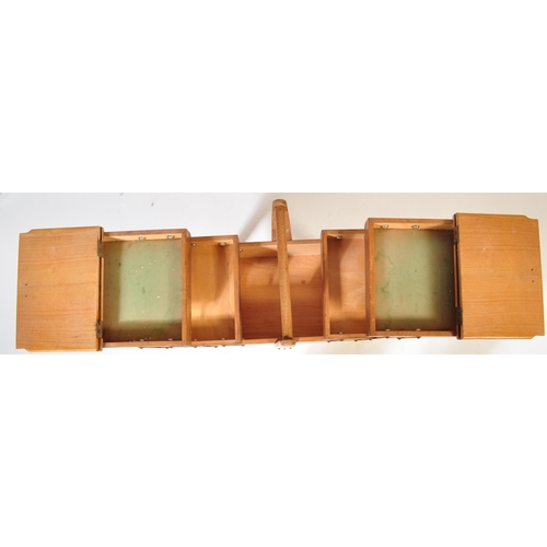 574 - A vintage retro mid 20th century circa. 1960's teak wood metamorphic sewing box having bar handle wi... 