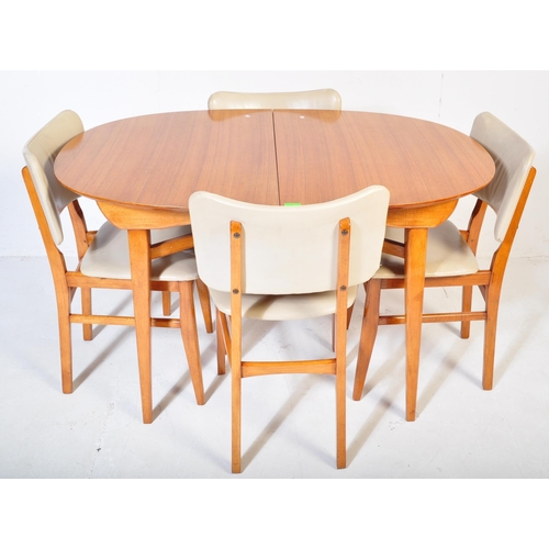 575 - A retro vintage mid 20th Century teak wood extending dining table with four chairs. The table having... 