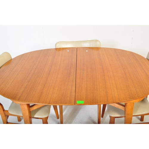 575 - A retro vintage mid 20th Century teak wood extending dining table with four chairs. The table having... 