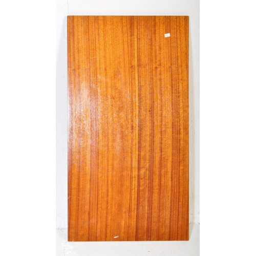 575 - A retro vintage mid 20th Century teak wood extending dining table with four chairs. The table having... 