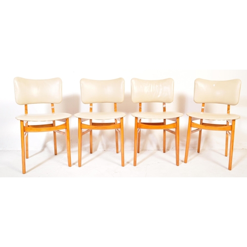 575 - A retro vintage mid 20th Century teak wood extending dining table with four chairs. The table having... 