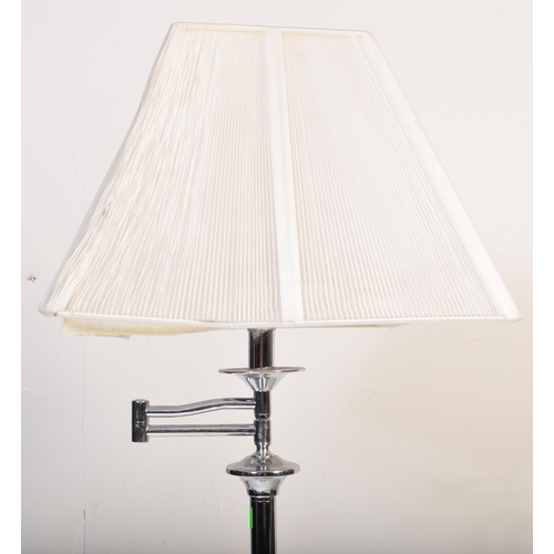 591 - A contemporary floor standing standard lamp light. Having a white netted shade, with a chrome tubula... 