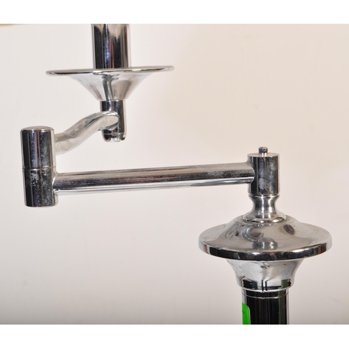 591 - A contemporary floor standing standard lamp light. Having a white netted shade, with a chrome tubula... 