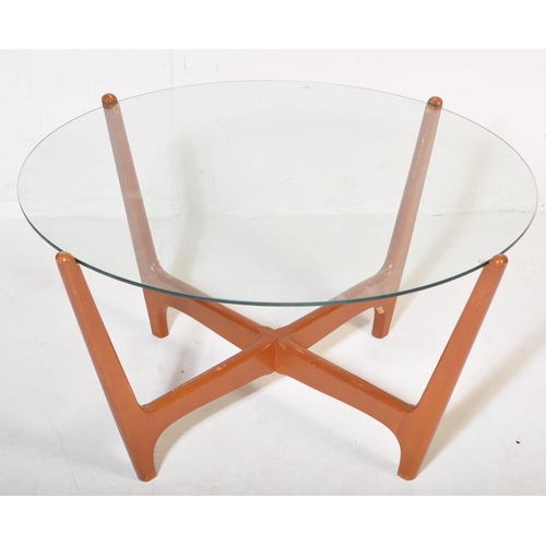 594 - A mid 20th Century retro vintage atomic teak and glass coffee table. Having a circular glass panel r... 