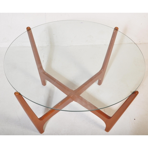 594 - A mid 20th Century retro vintage atomic teak and glass coffee table. Having a circular glass panel r... 