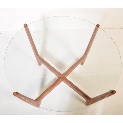594 - A mid 20th Century retro vintage atomic teak and glass coffee table. Having a circular glass panel r... 