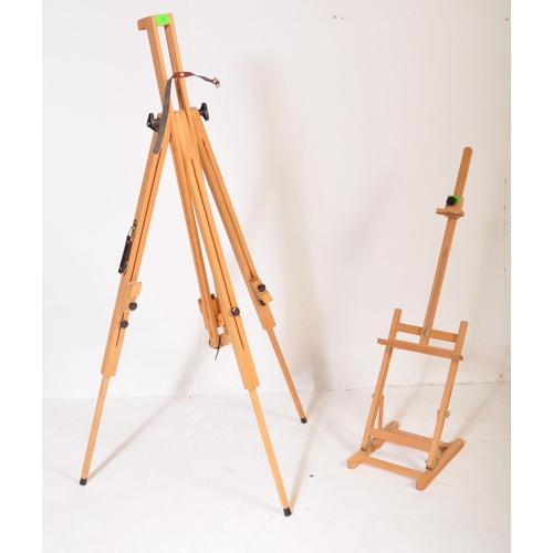 598 - A contemporary modern artists beech wood adjustable easel stand raised on tripod supports. Together ... 