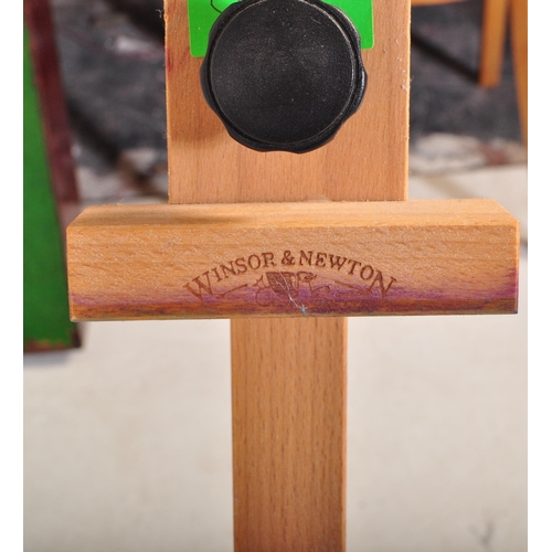 598 - A contemporary modern artists beech wood adjustable easel stand raised on tripod supports. Together ... 