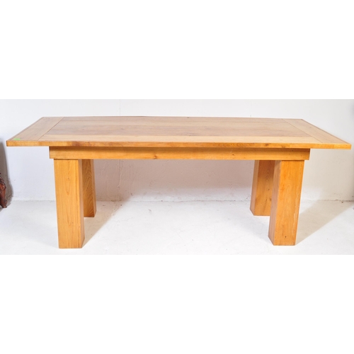 600 - A large contemporary modernist oak refectory dining table. Large squared oak column legs with fitted... 