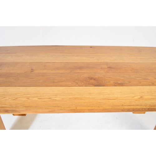600 - A large contemporary modernist oak refectory dining table. Large squared oak column legs with fitted... 