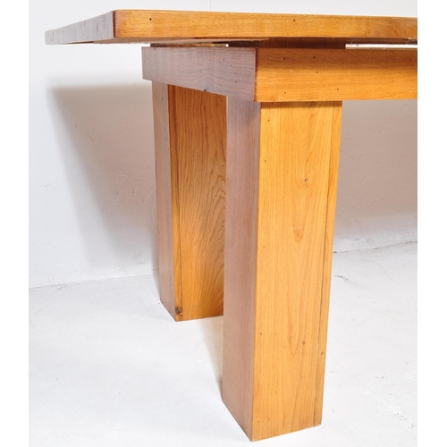 600 - A large contemporary modernist oak refectory dining table. Large squared oak column legs with fitted... 