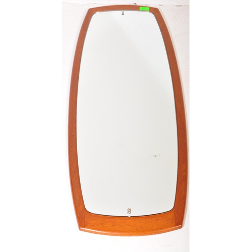 637 - A retro vintage mid 20th Century teak framed wall hanging mirror of curved rectangular form. It meas... 