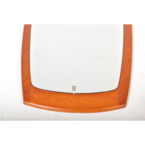 637 - A retro vintage mid 20th Century teak framed wall hanging mirror of curved rectangular form. It meas... 