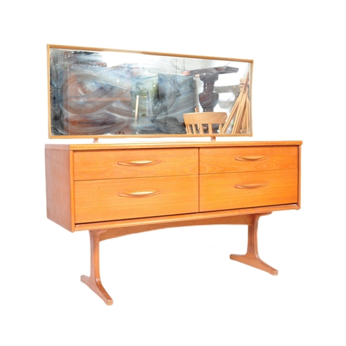 645 - Mid century teak wood dressing table being raised on splayed legs with suspended body of four deep d... 