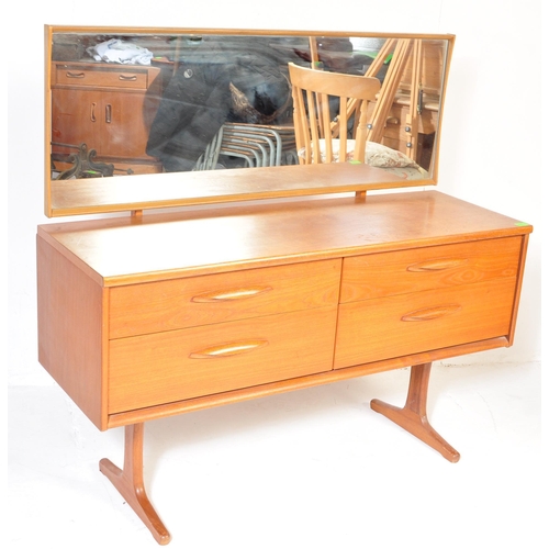 645 - Mid century teak wood dressing table being raised on splayed legs with suspended body of four deep d... 