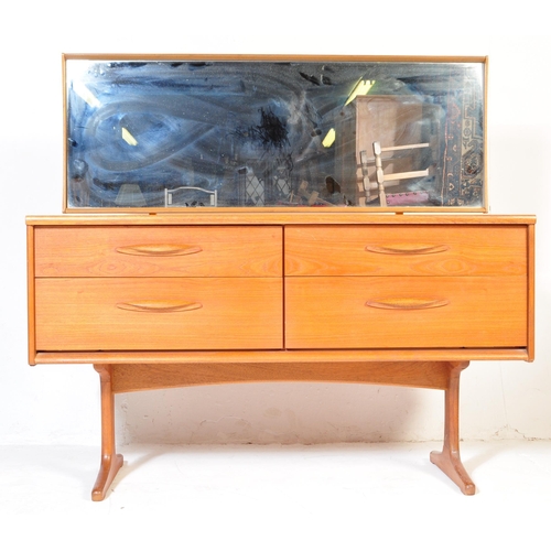 645 - Mid century teak wood dressing table being raised on splayed legs with suspended body of four deep d... 
