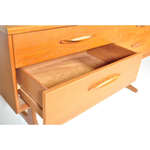 645 - Mid century teak wood dressing table being raised on splayed legs with suspended body of four deep d... 