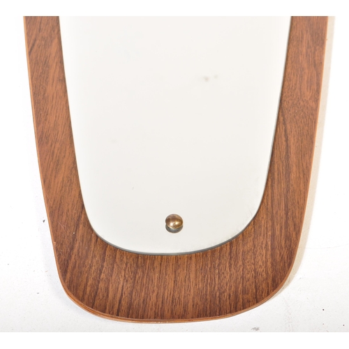 650 - A retro vintage mid 20th Century teak framed asymmetric mirror of tapering form. It measures approx.... 