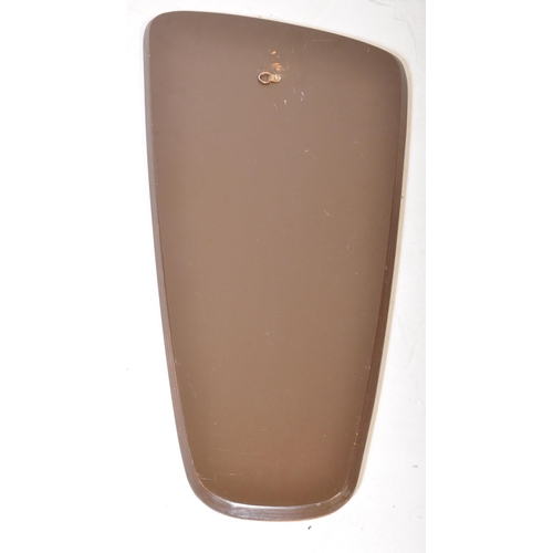 650 - A retro vintage mid 20th Century teak framed asymmetric mirror of tapering form. It measures approx.... 