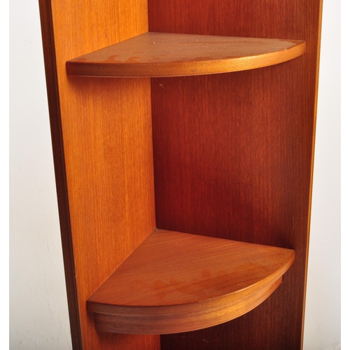 656 - William Lawrence - A retro mid 20th Century teak corner cabinet having a slender shelf top raised on... 
