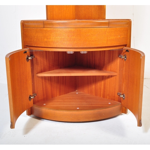 656 - William Lawrence - A retro mid 20th Century teak corner cabinet having a slender shelf top raised on... 