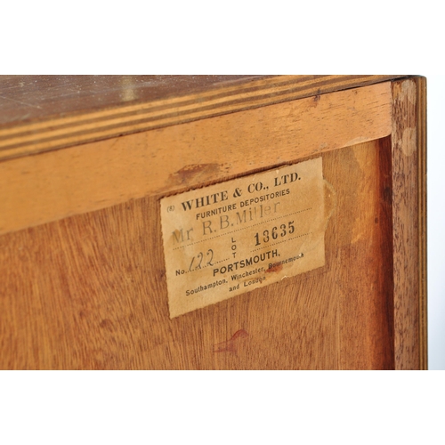 657 - A retro mid 20th Century walnut veneer childrens wardrobe / chest tallboy having a fall length wardr... 