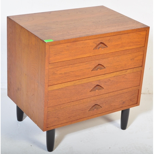 661 - A retro 20th Century small teak chest of drawers / bedside chest having four drawers each with carve... 