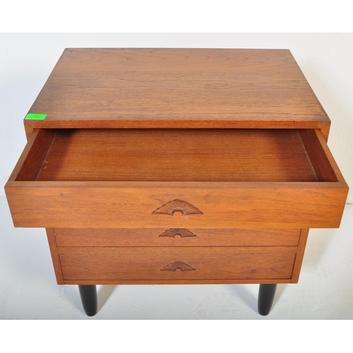 661 - A retro 20th Century small teak chest of drawers / bedside chest having four drawers each with carve... 