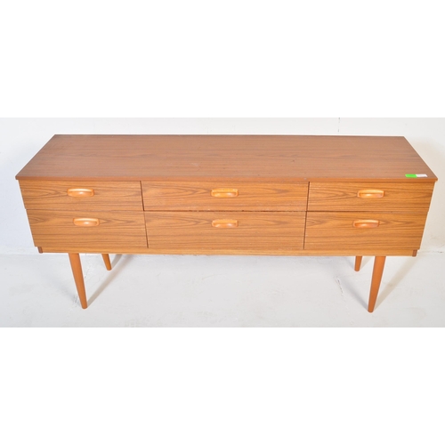 666 - A retro 20th Century teak chest of drawers / sideboard credenza having six drawers each with recesse... 