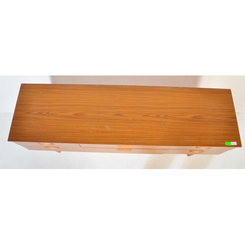 666 - A retro 20th Century teak chest of drawers / sideboard credenza having six drawers each with recesse... 