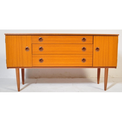 670 - A retro vintage mid 20th Century teak sideboard credenza by Schreiber. Bank of three drawers flanked... 