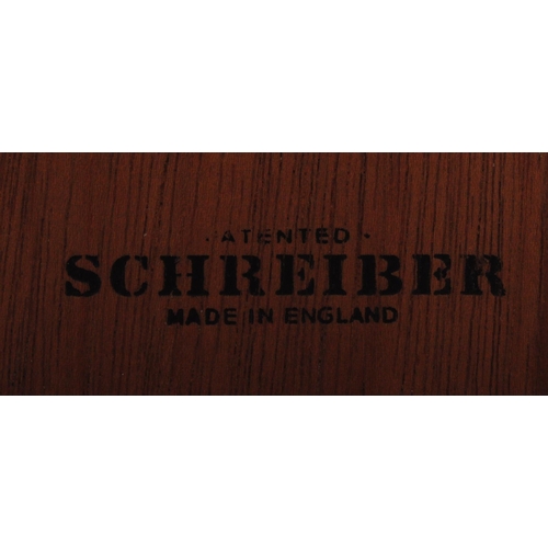 670 - A retro vintage mid 20th Century teak sideboard credenza by Schreiber. Bank of three drawers flanked... 