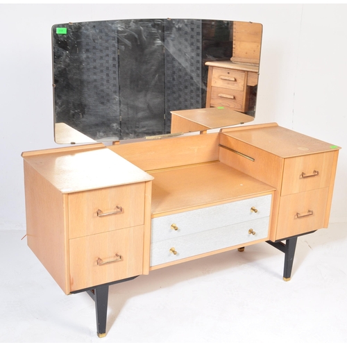 698 - A retro mid 20th Century light oak-ply dressing table chest in the manner of G Plan having a framele... 