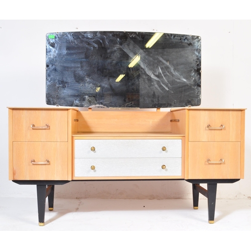 698 - A retro mid 20th Century light oak-ply dressing table chest in the manner of G Plan having a framele... 